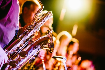 A man playing jazz on a saxophone. Photo by [Jens Thekkeveettil](https://unsplash.com/@jensth?utm_content=creditCopyText&utm_medium=referral&utm_source=unsplash) on [Unsplash](https://unsplash.com/photos/person-playing-saxophone-dBWvUqBoOU8?utm_content=creditCopyText&utm_medium=referral&utm_source=unsplash)
